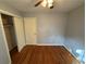 Simple bedroom with hardwood floors and a double door closet at 2534 Sharpsburg Ct, Decatur, GA 30034