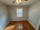 Cozy bedroom with hardwood floors and a large window at 2534 Sharpsburg Ct, Decatur, GA 30034