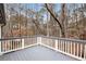 Relaxing deck with gray flooring and white railings overlooks a wooded backdrop at 170 Remington Ln, Acworth, GA 30101