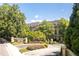 Luxury condo building with gated entrance, lush landscaping, and meticulously maintained grounds at 2865 Lenox Ne Rd # 208, Atlanta, GA 30324