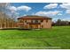 Expansive backyard featuring a well-maintained lawn, partially covered patio, and a lovely view at 2571 Se Ebenezer Rd, Conyers, GA 30094