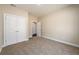 Large bedroom with plush carpeting, white trim, neutral paint, and closet with double doors at 2571 Se Ebenezer Rd, Conyers, GA 30094