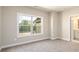 Bedroom with large window offering neighborhood views and carpeted floors at 2571 Se Ebenezer Rd, Conyers, GA 30094