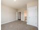 Carpeted bedroom with neutral walls, showcasing a doorway and access to a bathroom at 2571 Se Ebenezer Rd, Conyers, GA 30094