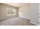 Bright bedroom with a large window and plush carpeting at 2571 Se Ebenezer Rd, Conyers, GA 30094