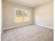Neutral bedroom with a large window providing lots of natural light and plush, neutral carpeting at 2571 Se Ebenezer Rd, Conyers, GA 30094