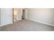 Bedroom featuring carpeted floors and an open doorway to a hallway and bathroom at 2571 Se Ebenezer Rd, Conyers, GA 30094