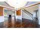Dining room with hardwood floors, wainscoting, chandelier, and view into living room and staircase at 2571 Se Ebenezer Rd, Conyers, GA 30094