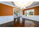 Dining room featuring hardwood floors, chandelier, wainscoting, and a large window at 2571 Se Ebenezer Rd, Conyers, GA 30094