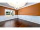 Dining room featuring hardwood floors, wainscoting, chandelier, and view into backyard at 2571 Se Ebenezer Rd, Conyers, GA 30094