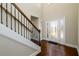 Inviting entryway featuring hardwood floors, a staircase, and a decorative glass front door at 2571 Se Ebenezer Rd, Conyers, GA 30094