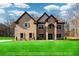 Stunning two-story brick home featuring a manicured lawn, stately architecture, and inviting curb appeal on a sunny day at 2571 Se Ebenezer Rd, Conyers, GA 30094