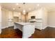 Bright kitchen with a large granite island, stainless appliances, and hardwood floors at 2571 Se Ebenezer Rd, Conyers, GA 30094