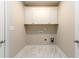 Laundry room with white cabinets, utility connections, and tile floors at 2571 Se Ebenezer Rd, Conyers, GA 30094