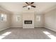 Sunlit living room featuring a modern electric fireplace and large windows at 2571 Se Ebenezer Rd, Conyers, GA 30094