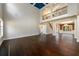 Spacious living room showcasing hardwood floors, a striking vaulted ceiling, and an open layout to the staircase and dining room at 2571 Se Ebenezer Rd, Conyers, GA 30094