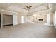 Spacious living room featuring a tray ceiling, fireplace, and ample natural light at 2571 Se Ebenezer Rd, Conyers, GA 30094