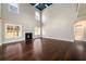 Large living room boasts a cozy fireplace, tall ceilings, hardwood floors, and ample natural light from surrounding windows at 2571 Se Ebenezer Rd, Conyers, GA 30094