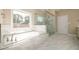 Primary bathroom featuring a soaking tub, glass enclosed shower, and marble tile at 2571 Se Ebenezer Rd, Conyers, GA 30094