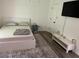 Cozy bedroom with minimalist decor, featuring a bed, TV, and ample natural light for relaxation at 2290 Wilkins Cv, Decatur, GA 30035