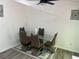 Dining area with glass table and four brown chairs at 2290 Wilkins Cv, Decatur, GA 30035
