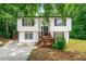 Charming two-story home with a landscaped yard and welcoming entryway, surrounded by lush trees at 2290 Wilkins Cv, Decatur, GA 30035