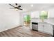 Well-lit kitchen area with stainless steel appliances and bright white cabinets adjacent to outdoor deck at 2290 Wilkins Cv, Decatur, GA 30035