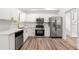 Modern kitchen with stainless steel appliances, white cabinetry, and quartz countertops for easy cooking at 2290 Wilkins Cv, Decatur, GA 30035