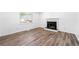 Spacious living room with wood flooring, a fireplace and a large window providing lots of natural light at 2290 Wilkins Cv, Decatur, GA 30035