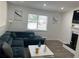 Cozy living room featuring a large sectional couch, fireplace, modern decor and great natural light at 2290 Wilkins Cv, Decatur, GA 30035