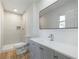 Modern bathroom with gray vanity and a large mirror at 488 Village Run, Lawrenceville, GA 30046