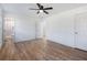 Large bedroom with wood-like flooring, ceiling fan and en-suite bath at 488 Village Run, Lawrenceville, GA 30046