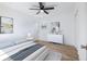 Bright bedroom with a queen-size bed, a dresser, and hardwood floors at 488 Village Run, Lawrenceville, GA 30046