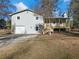 Newly renovated house with gray siding, a detached garage, and a wooden deck at 488 Village Run, Lawrenceville, GA 30046