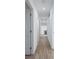 Long hallway with light walls and hardwood floors at 488 Village Run, Lawrenceville, GA 30046