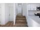 Hallway with hardwood floors and stairs leading to upper level at 488 Village Run, Lawrenceville, GA 30046