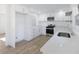 Modern kitchen with white cabinets, stainless steel appliances and quartz countertops at 488 Village Run, Lawrenceville, GA 30046