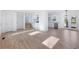 Open concept living area with hardwood floors, kitchen, and back door access at 488 Village Run, Lawrenceville, GA 30046