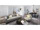 Spacious living room features gray couch and armchairs, and an open floor plan at 488 Village Run, Lawrenceville, GA 30046