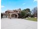 Elegant brick home showing porte-cochere, attached two-car garage and long paved driveway at 1255 Mcminn Way, Snellville, GA 30078