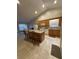 Open kitchen with granite countertops, an island, and dining area with natural light at 1060 S Creek Dr, Villa Rica, GA 30180
