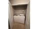 Functional laundry closet with a washing machine, dryer, and wire shelving for storage at 1060 S Creek Dr, Villa Rica, GA 30180