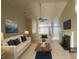 Bright living room with high ceilings, fireplace, ceiling fan, and modern furnishings at 1060 S Creek Dr, Villa Rica, GA 30180