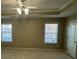 Bedroom showcasing two windows, a ceiling fan, and door to the bathroom at 230 Valley Xing, Canton, GA 30114