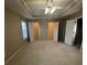 Large bedroom featuring a tray ceiling, ceiling fan, window, and two walk-in closets at 230 Valley Xing, Canton, GA 30114