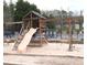 Community playground featuring a wooden playset with a slide and swings, perfect for Gathering fun at 230 Valley Xing, Canton, GA 30114