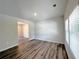 Spacious living room with wood-look floors and access to other rooms at 1102 Campbell Rd, Covington, GA 30014