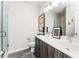 Bathroom with double vanity, gray cabinets, and a walk-in shower at 462 Latta Ne St, Atlanta, GA 30308