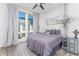 Bright bedroom with a large bed, floor-to-ceiling windows, and gray bedding at 462 Latta Ne St, Atlanta, GA 30308