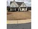 Two-story white farmhouse with a dark gray roof and landscaping at 4730 Down Setting Rd, Cumming, GA 30028